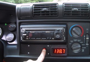 A red LED volt meter mounted in the dash