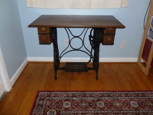 Wood tabletop mounted on a cast iron sewing machine base